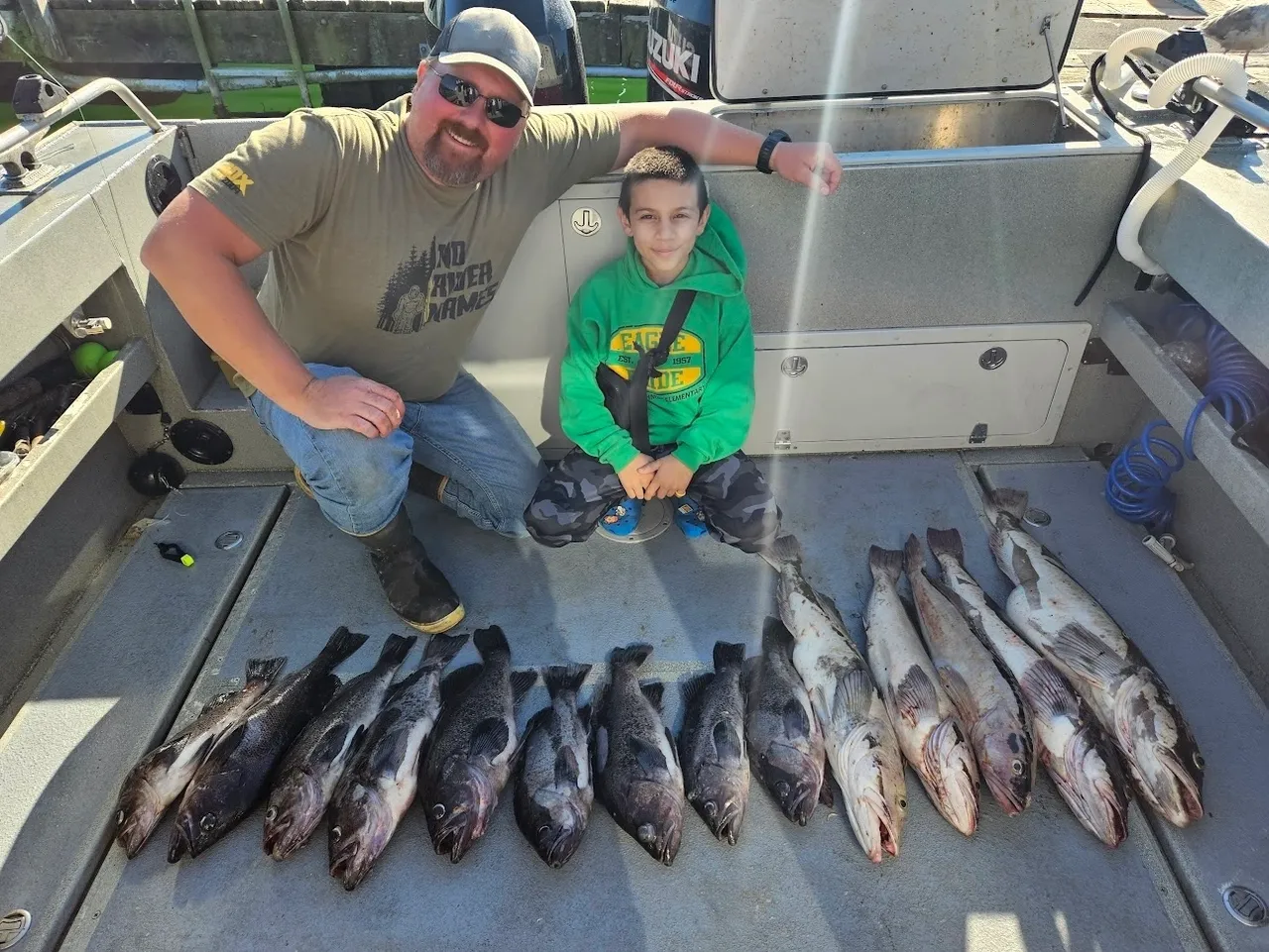 Two people with freshly caught fish.
