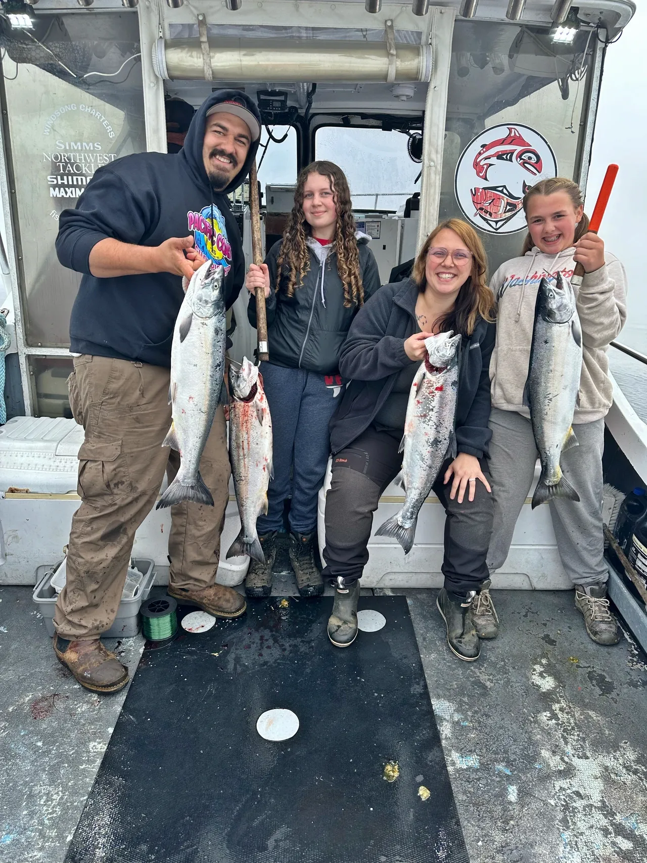 Group proudly holding freshly caught fish.
