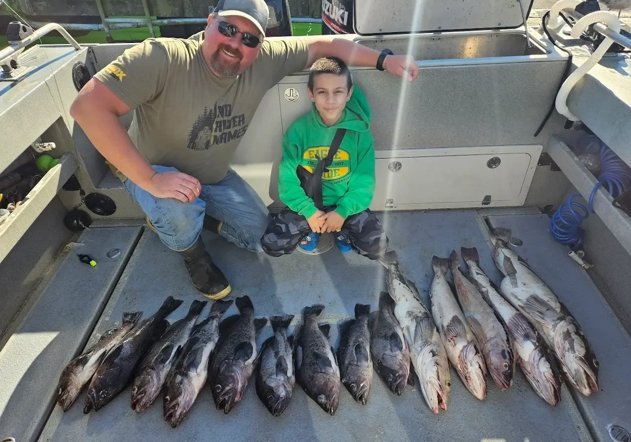Two people with freshly caught fish.
