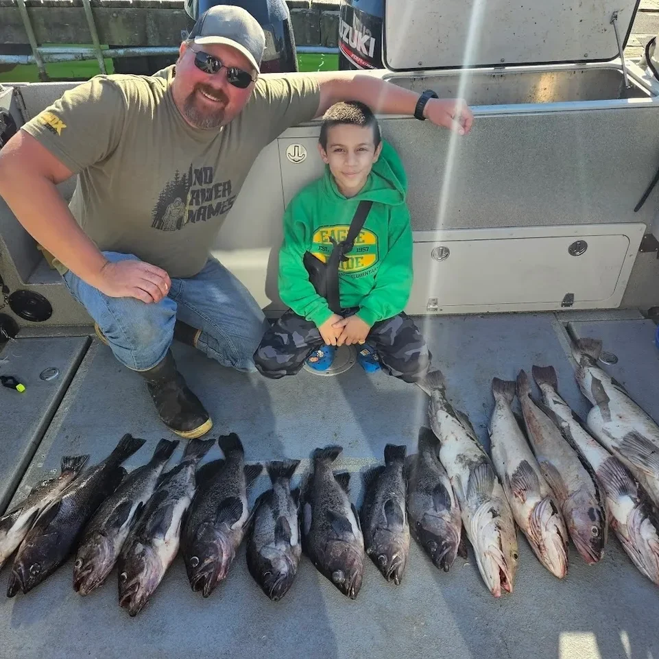 Two people with freshly caught fish.