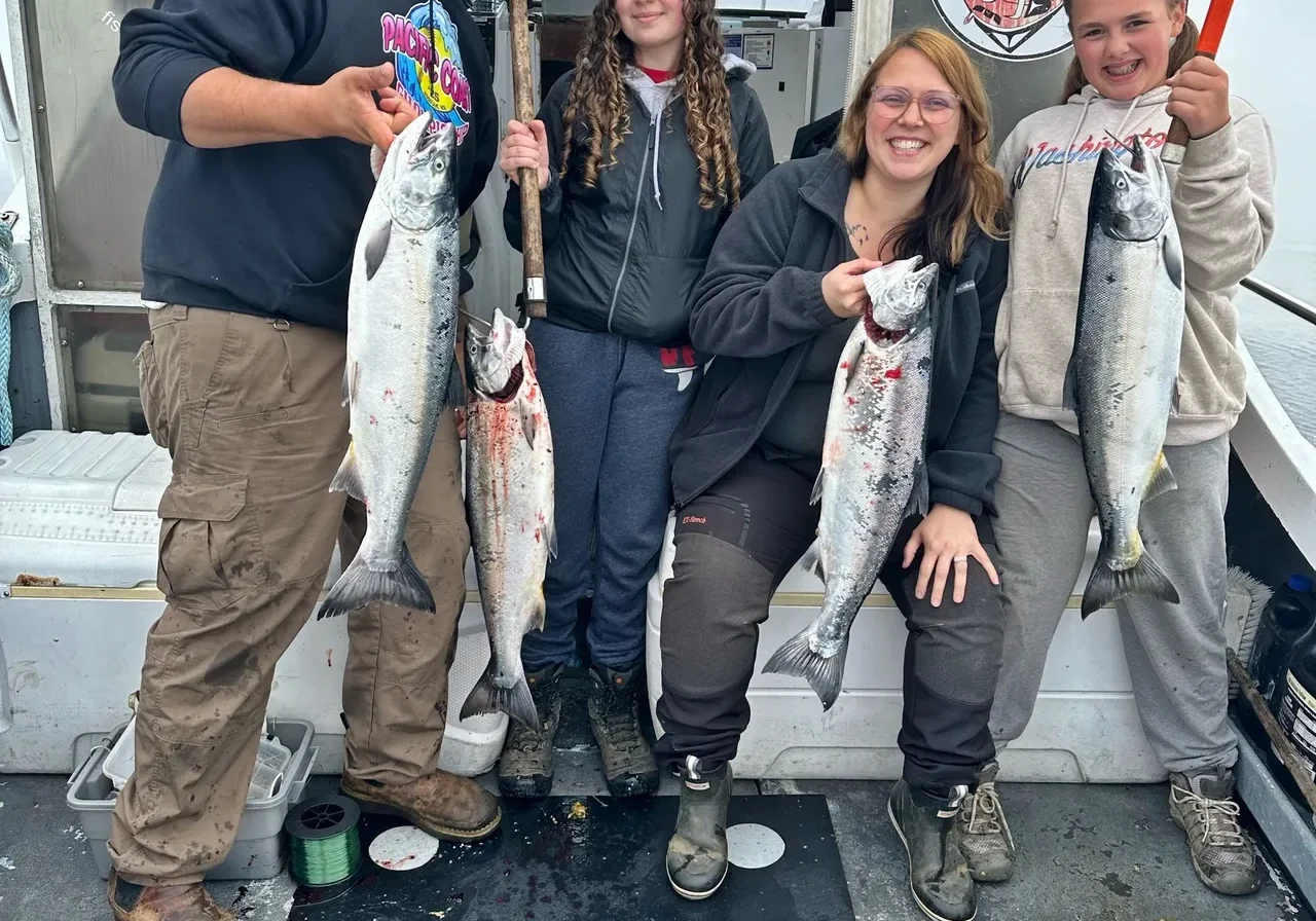 Group proudly holding freshly caught fish.