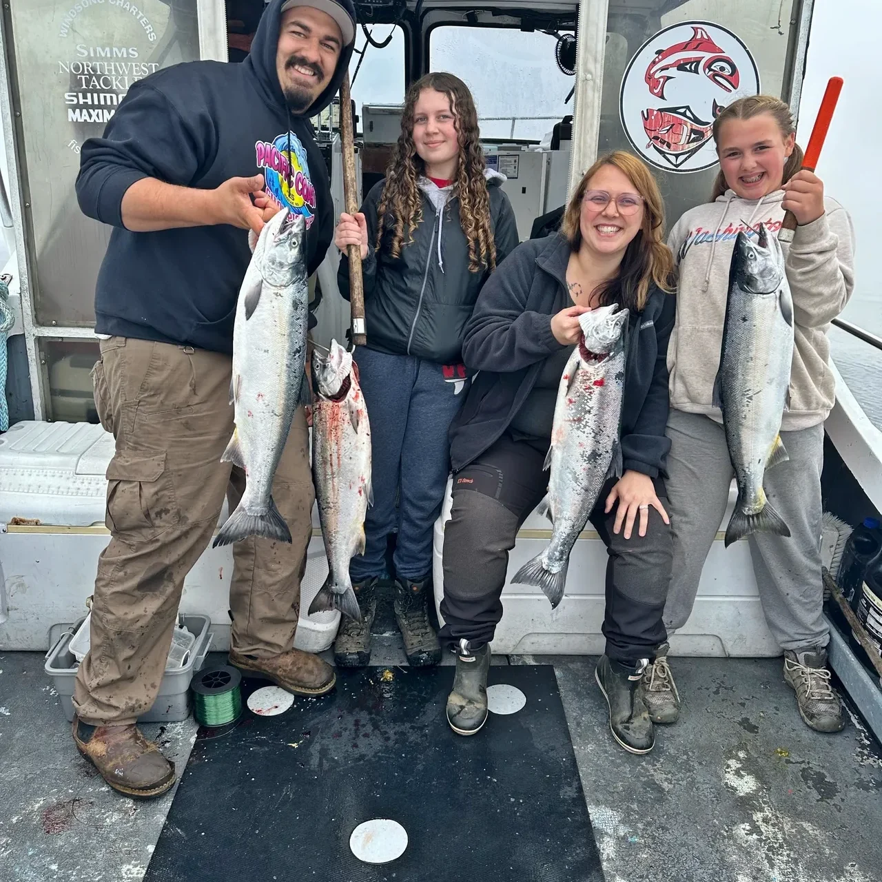 Group proudly holding freshly caught fish.